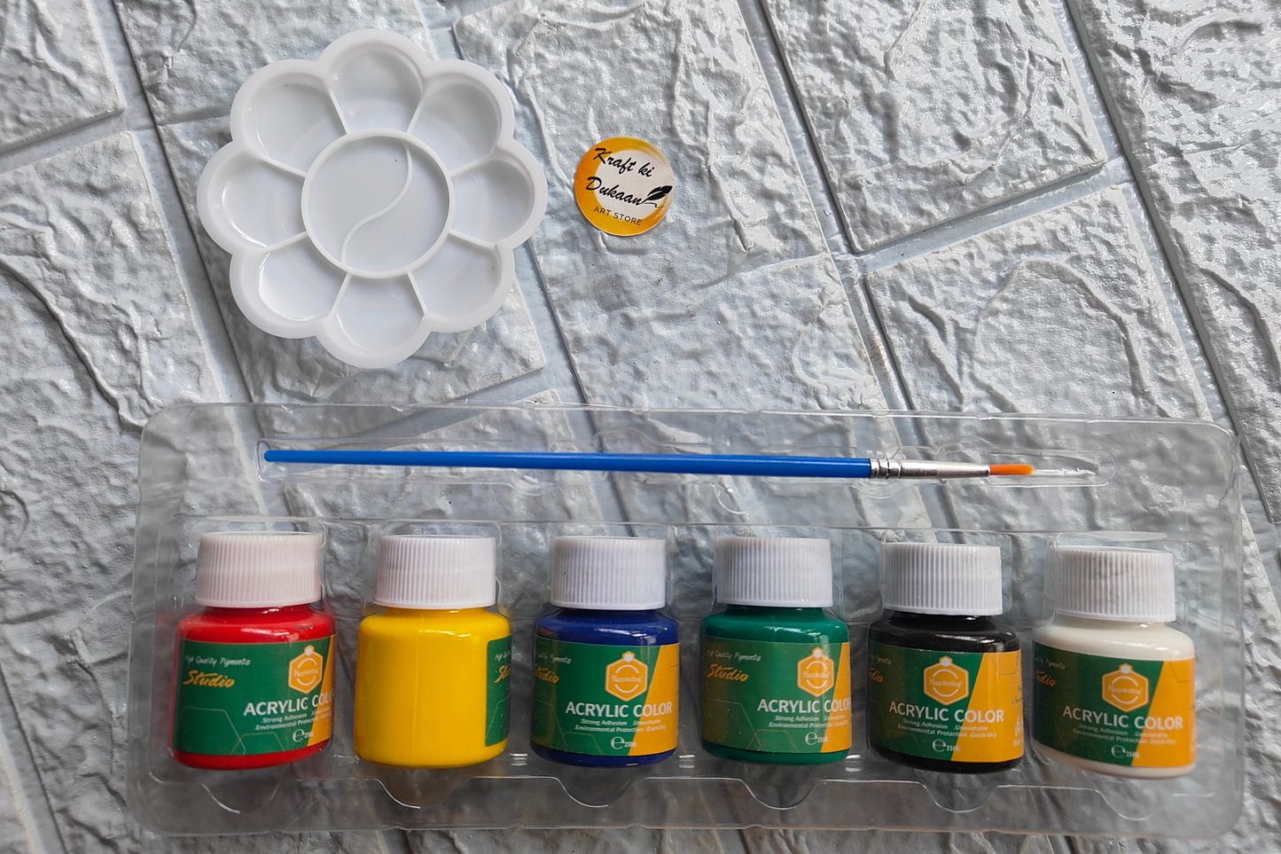 Beginner acrylic paint kit with six vibrant paint colors and a brush for easy crafting